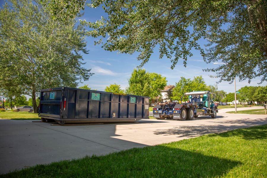 dumpster delivered on a drive way