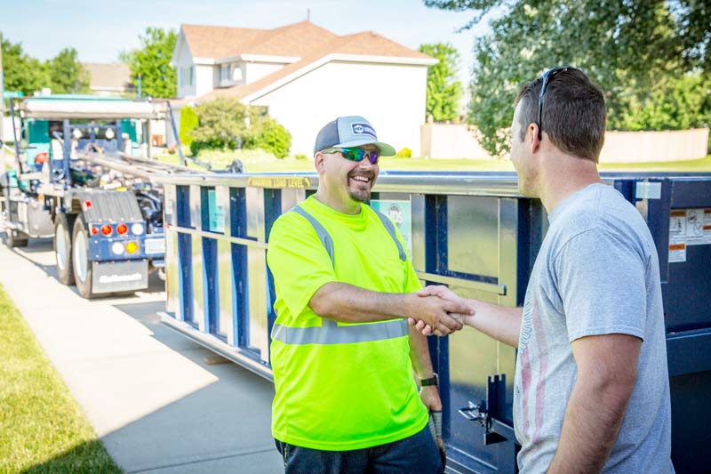 shake-hands-moving-out-dumpster