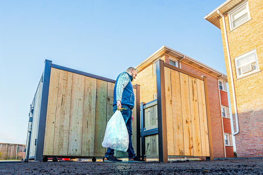 Garbage enclosure fence bags of garbage loading