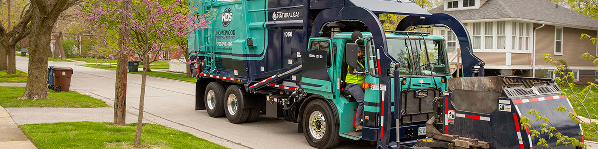 residential garbage truck making a stop