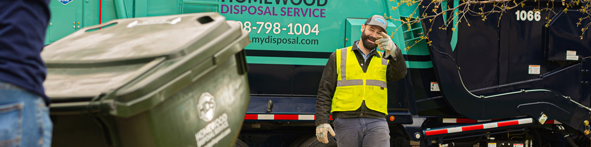 garbage truck driver smiling and waving at a customer