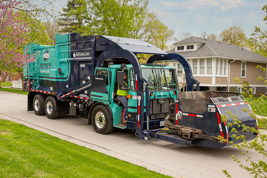 garbage truck making a stop in a residential neighborhood
