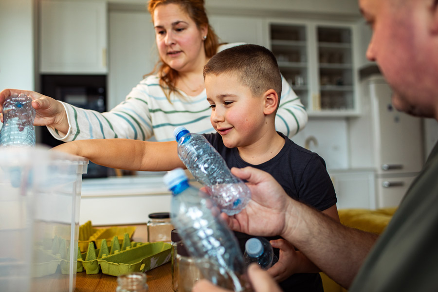 A family recycling at the kitchen table